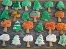 Tree-shaped cookies decorated for fall with icing.