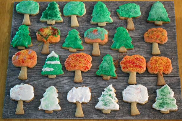 Tree-shaped cookies decorated for fall with icing.