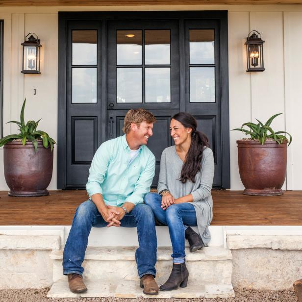 Hosts Chip and Joanna Gaines on the porch of the Zan family's newly remodeled house, as seen on Fixer Upper.