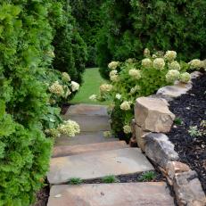 Bluestone pavers provide an enticing descent into a hidden backyard