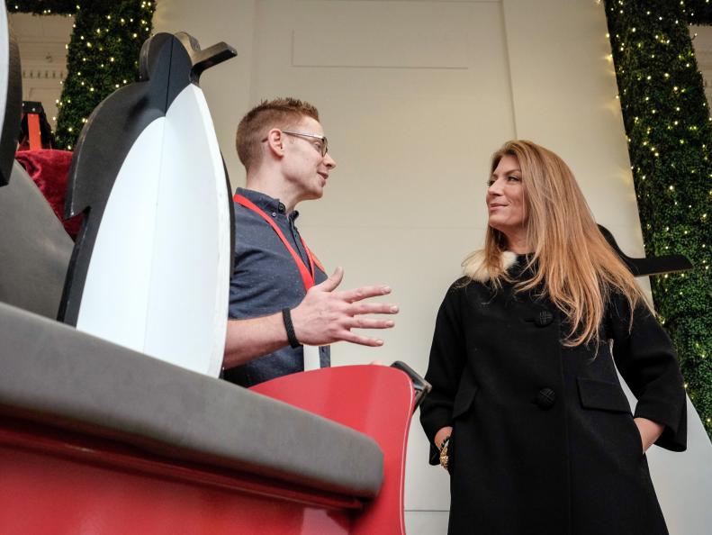As seen on HGTV's White House Christmas 2015, Genevieve Gorder talks with Christmas decorator volunteer as he puts together ornaments on at the East entrance to the White House November 30, 2015.