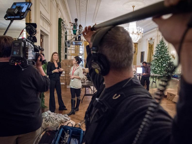 As seen on HGTV's White House Christmas 2015, Genevieve Gorder  talks with tape artist and designer Sarah Anne Dinardo in the East Room of the White House November 30, 2015.