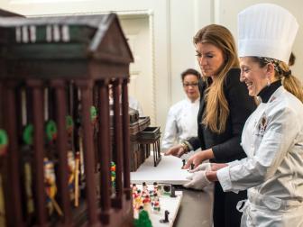 As seen on HGTV's White House Christmas 2015, Genevieve Gorder helps move the West Wing portion of the Gingerbread house with White House Pastry Chef Susie Morrison before transporting the Gingerbread House upstairs to the State Room of the White House.