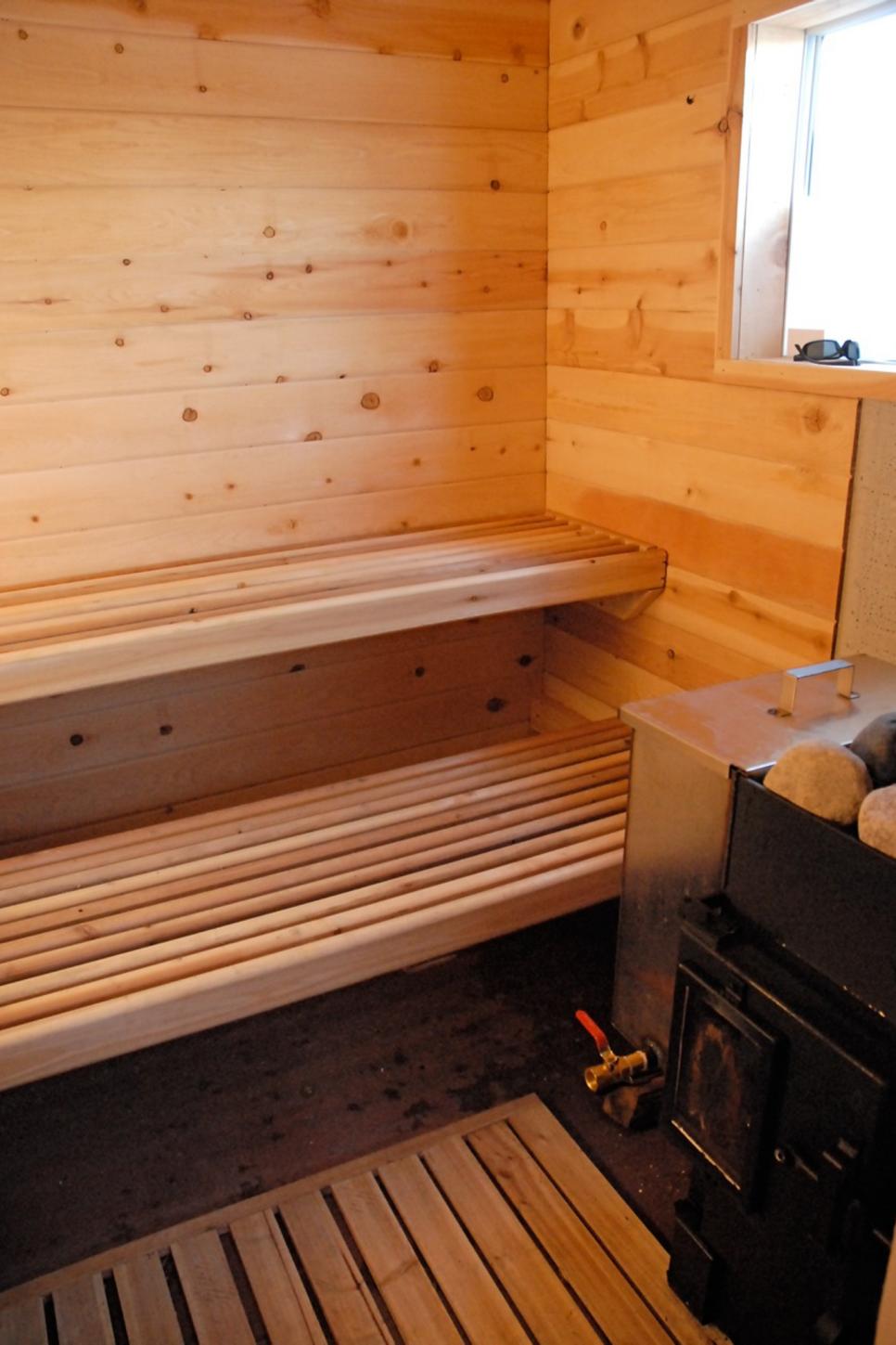 Outdoor Sauna with Cedar Walls and a Stove | HGTV