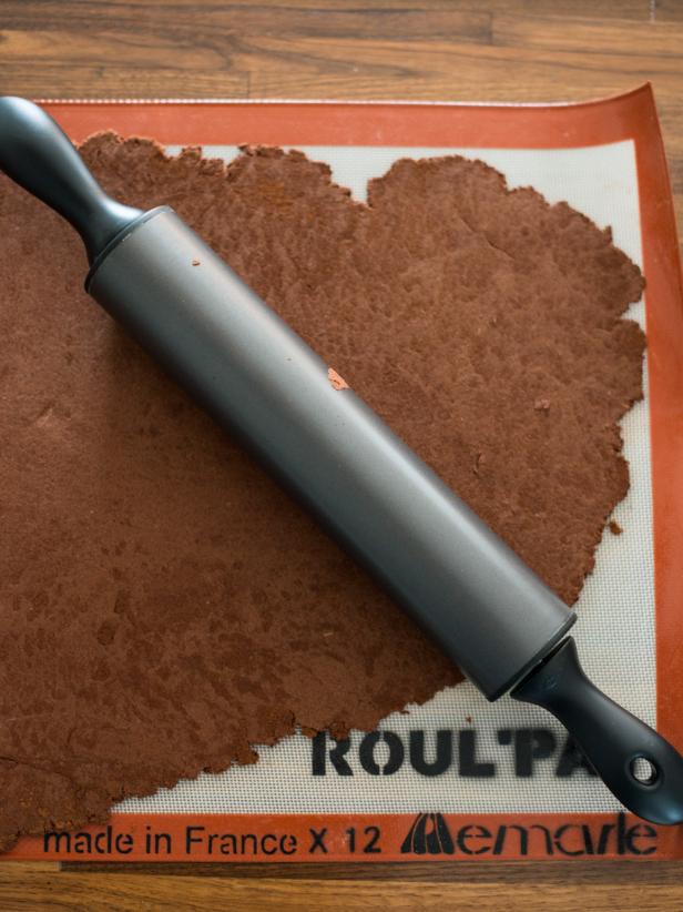 Dust dough and rolling surface with extra cinnamon to prevent it from sticking.  Roll out with a rolling pin to about ¼” thickness.