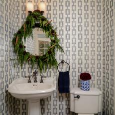 Powder Room With Mirror Trimmed in Greenery and Cinnamon Sticks