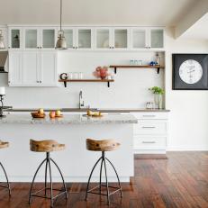 Country Kitchen With Modern Influence With White Brick Backsplash Wall, Wood Barstools and Floating Shelf Display 
