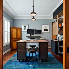 Powder Blue Contemporary Home Office With Industrial Desk, Vibrant Turquoise and Blue Rug and Organized Storage Space 