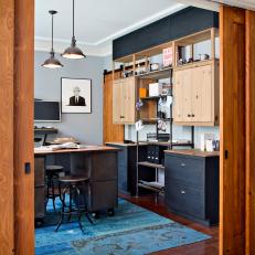 Contemporary Home Office With Industrial Influence Featuring Metal Desk, Open Shelving and Untreated Wood Cabinets 
