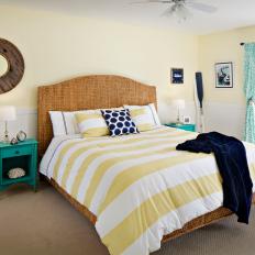 Bright Coastal Bedroom With Yellow and White Striped Comforter, Wicker Bed Frame and Headboard and Turquoise Accents