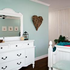 Light Turquoise Walls, A Beautiful White Dresser and Vanity and Deep, Rich Hardwood in Country Bedroom 