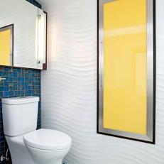 Colorful Contemporary Bathroom With Textured Wavy Walls, Small Blue and Yellow Tile Floor and Yellow Accent Panel 