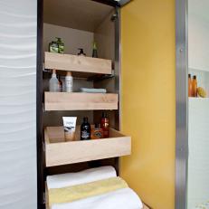 Built In Bathroom Cabinet With Roll Out Wood Shelves and Opaque Yellow Door 