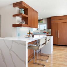 Midcentury Modern Kitchen Bar With Large Marble Crack Design, Cream Padded Barstools and Built In Shelves