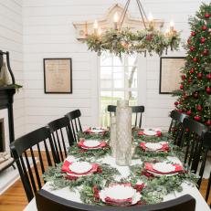 Festive Dining Room With Christmas Tree and Industrial Style Chandelier