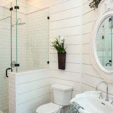 All-White Bathroom With Glass Enclosed Shower