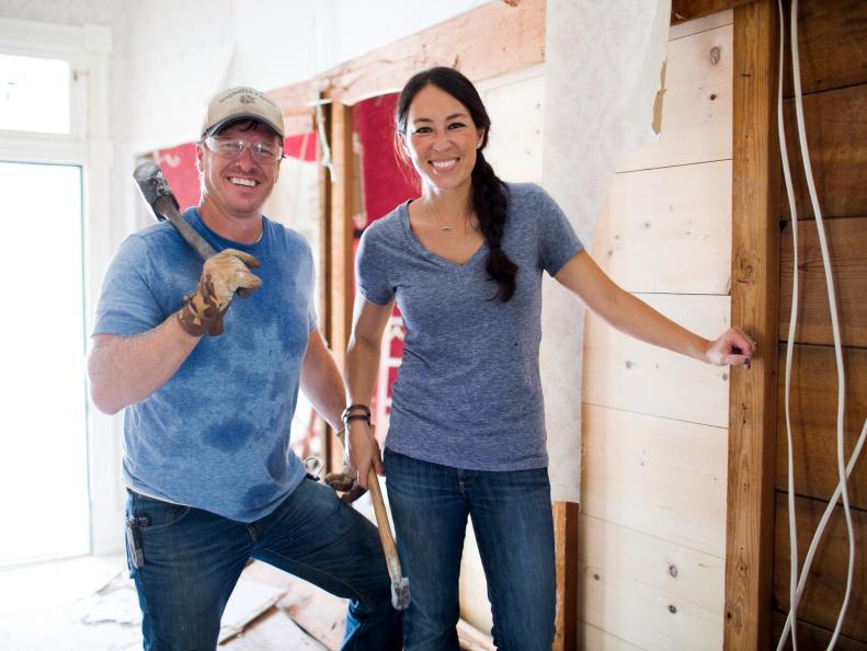 Hosts Chip and Joanna Gaines pose for a portrait while demolishing the entryway of the Bed and Breakfast, as seen on Fixer Upper. (portrait)