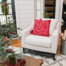 White Arm Chair With Holiday Throw Pillow in Living Room