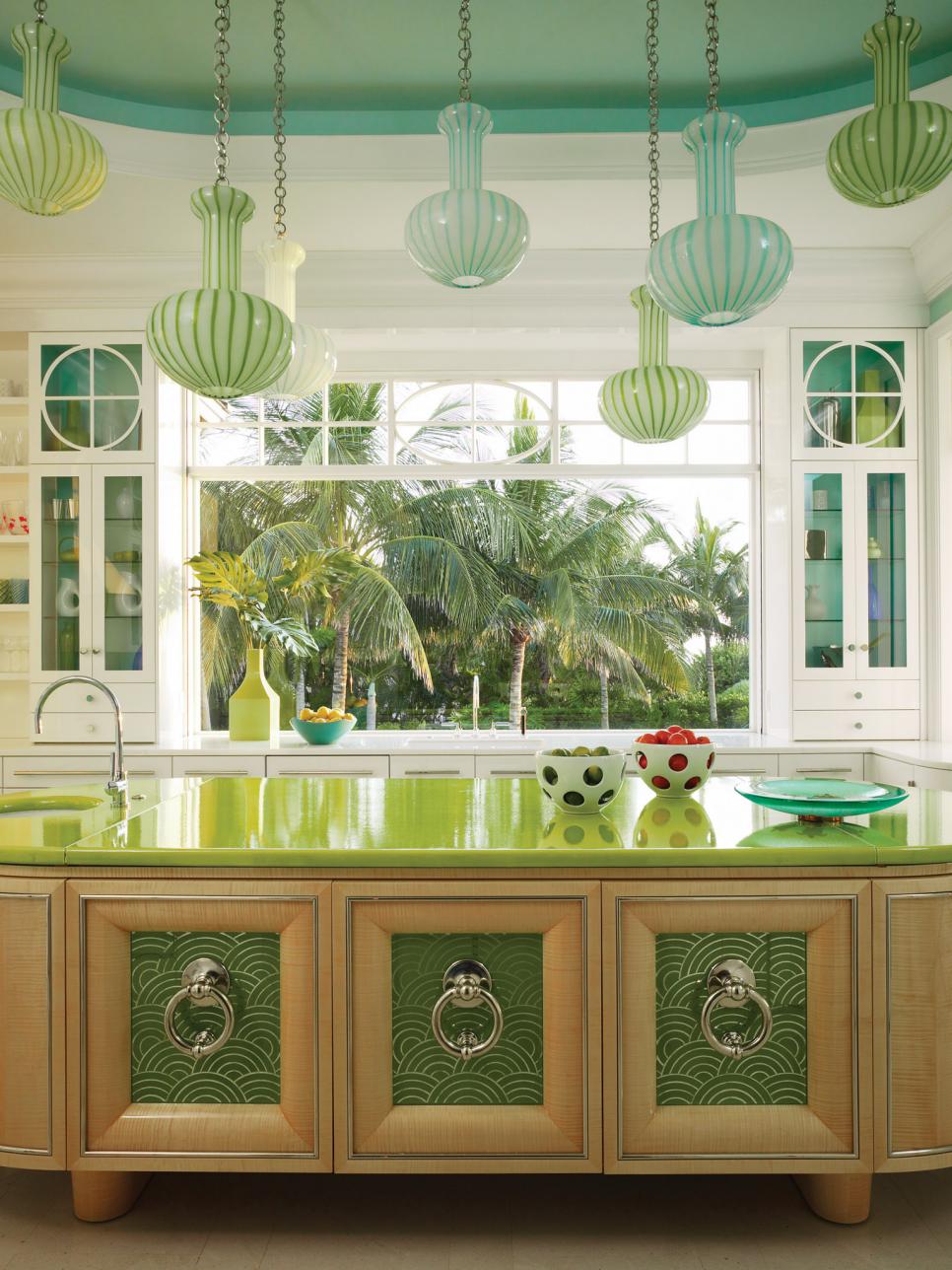 Sunny Kitchen With Oval Island and Colorful Pendant Lights | HGTV