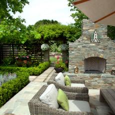 A Colored Stone Fireplace Anchors The Seating Area in a La Jolla Garden Courtyard 