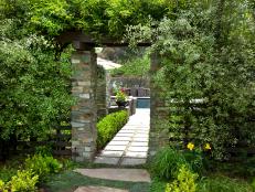 A Stonework Archway Hides Inside a Lush Garden Trellis
