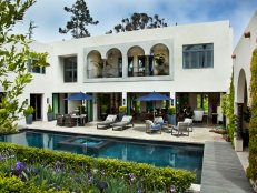 The archway terraces of a villa home overlooking a courtyard pool