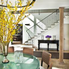 A Round Glass Table Takes Center Stage In A Downstairs Dining Room