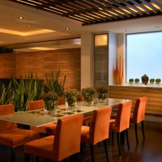 Neutral Contemporary Dining Room With Orange Chairs