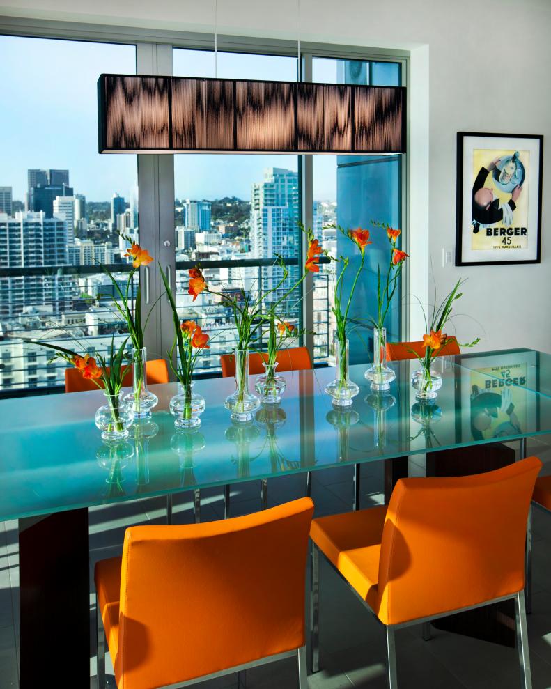 Urban Dining Room With Glass Dining Table, Orange Chairs
