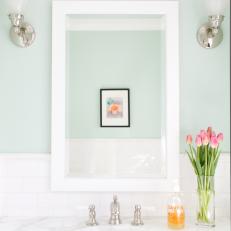 White Mirror and Marble Sink in Blue Bathroom