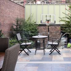 Patio With Basketball Hoop and Brick Wall