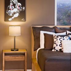 Brown Penthouse Bedroom Features Willie Nelson Art
