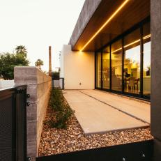 Modern Industrial Covered Patio With Warm Light Strip & Natural Rock Basin