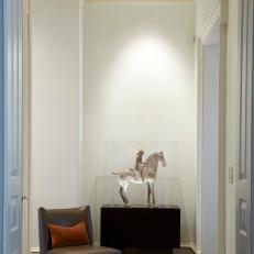 White Asian Hallway With Glass-Encased Horse Statue