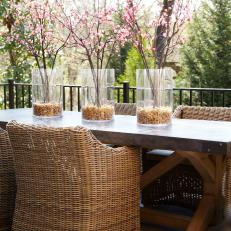 Asian-Inspired Outdoor Dining Space With Wicker Armchairs