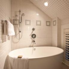 Bathtub and Shower With White Tile Backsplash
