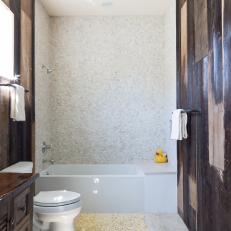 Brown and White Bathroom With Pebble Backsplash