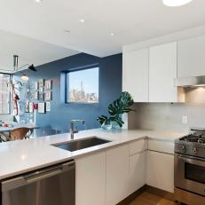 Open Plan Kitchen With Manhattan View & Blue Accent Wall