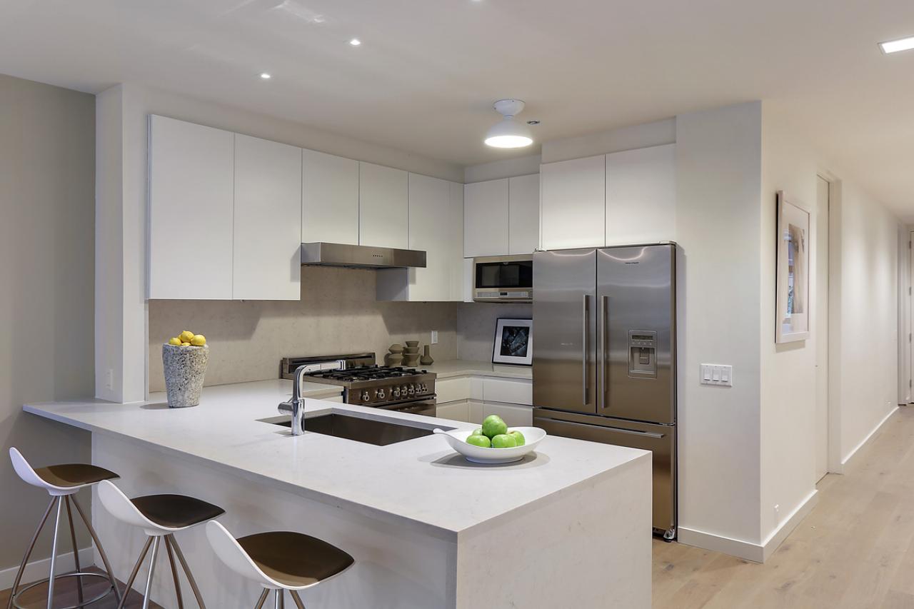 contemporary apartment kitchen area with crisp white closets|hgtv