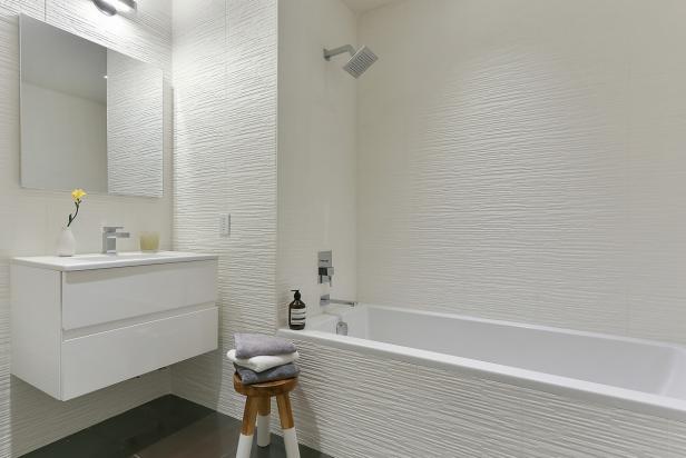 Crisp White Bathroom Boasts Floating Vanity Textured Tile Hgtv Boasts Floating Vanity Textured Tile