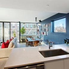 Contemporary Open Plan Condo With Bold Blue Accent Wall