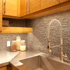 Brown Tile Kitchen Backsplash and Stainless Steel Countertop