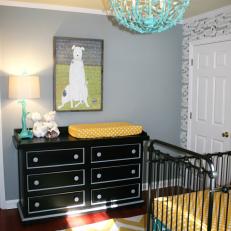 Twins' Nursery With Black Changing Table and Teal Metal Chandelier