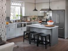 Defined by modern white cabinetry and a complementary gray island, this clever kitchen is packed with high-tech surprises.
