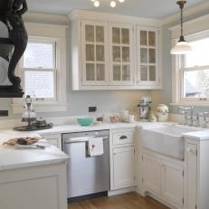 Charming Kitchen With White Cabinetry & Farmhouse Sink