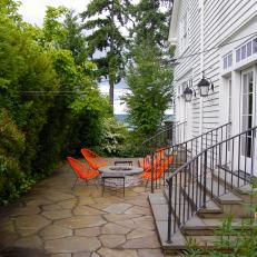 Outdoor Patio with Firepit and Bright Orange Chairs