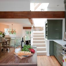 Green Cabinets and Rustic Elements in Open Plan Kitchen