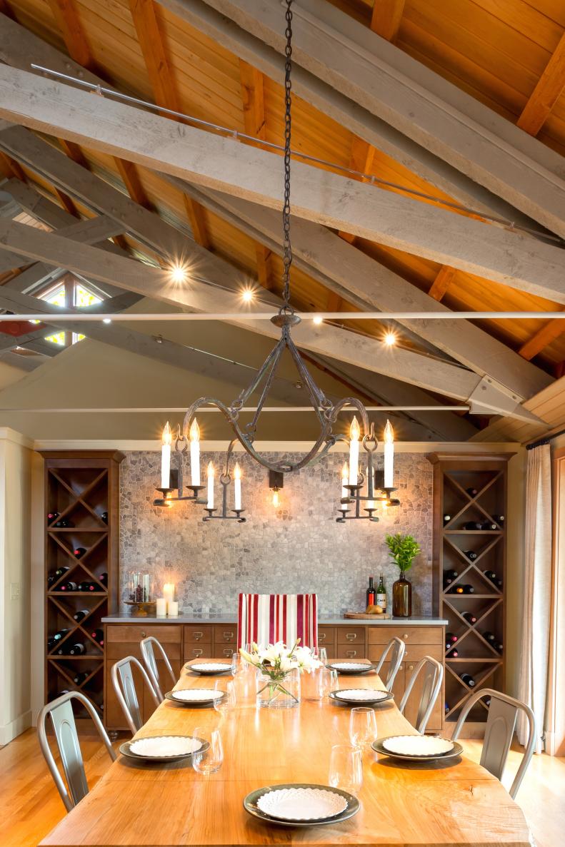 Neutral Dining Room With Wood Table, Metal Chandelier & Exposed Beams