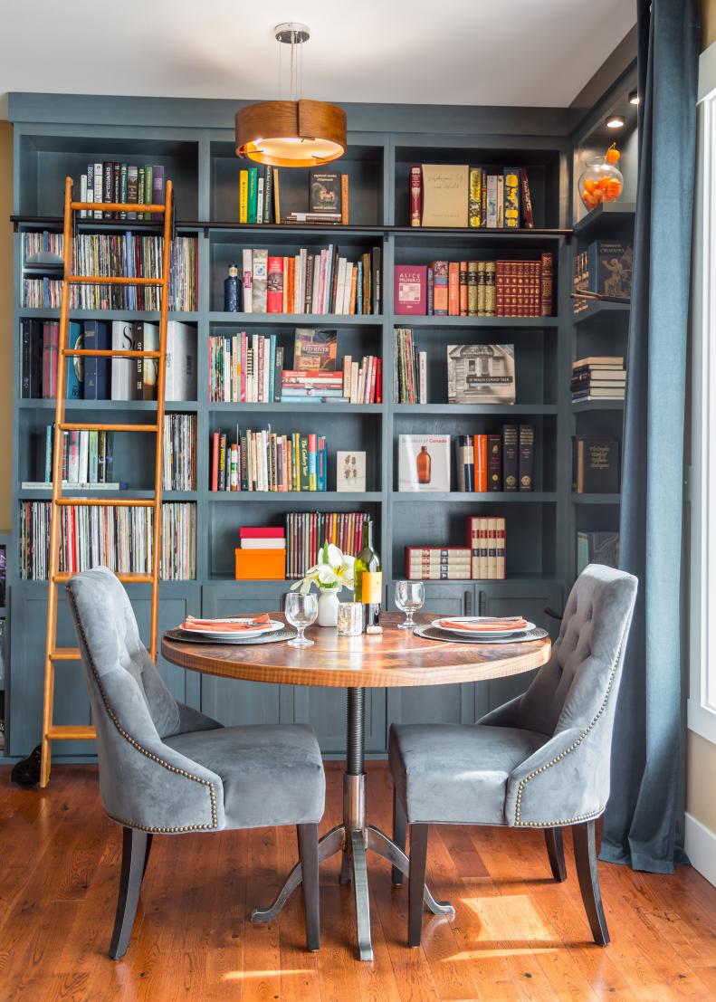 Blue Bookshelves Behind Intimate Dining Table for Two