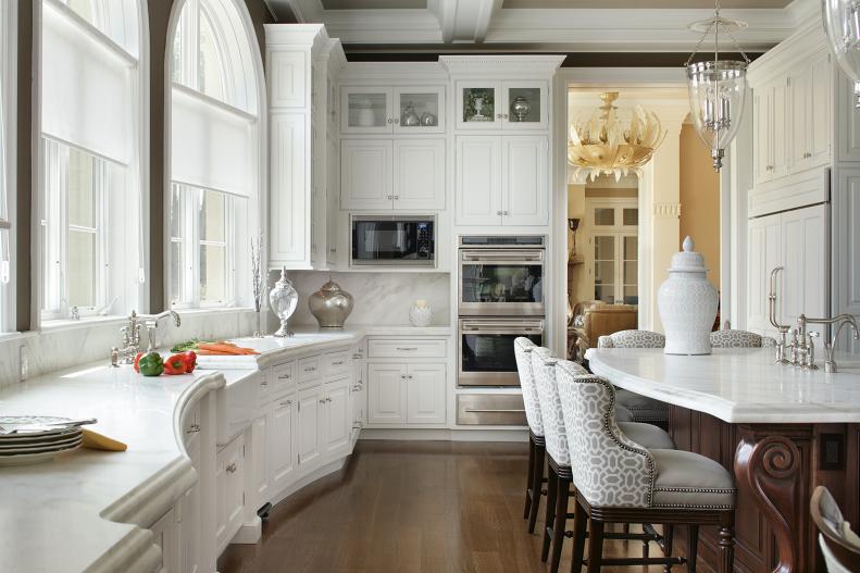 White Cabinetry in Traditional Kitchen With Walnut Island